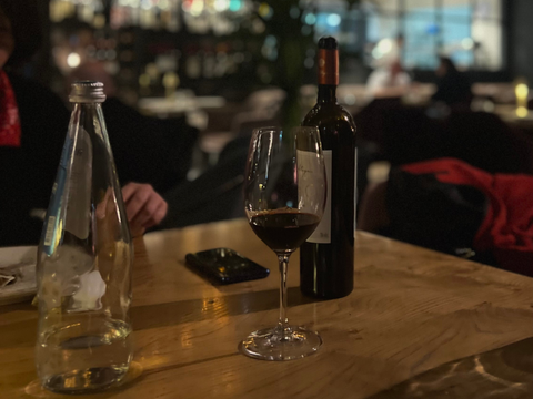 Best red wine gift. Red wine and glass on table.